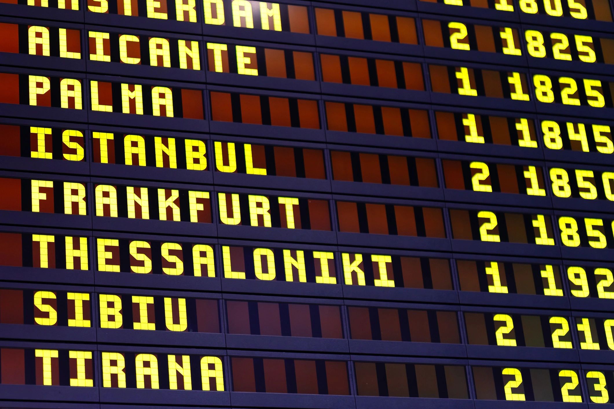 Airport departure board showing international travel destinations